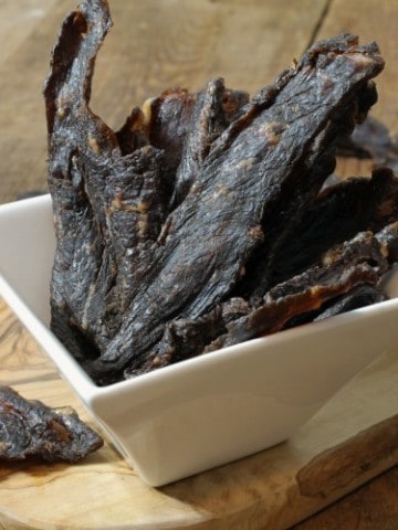 homemade beef jerky on a square white serving bowl
