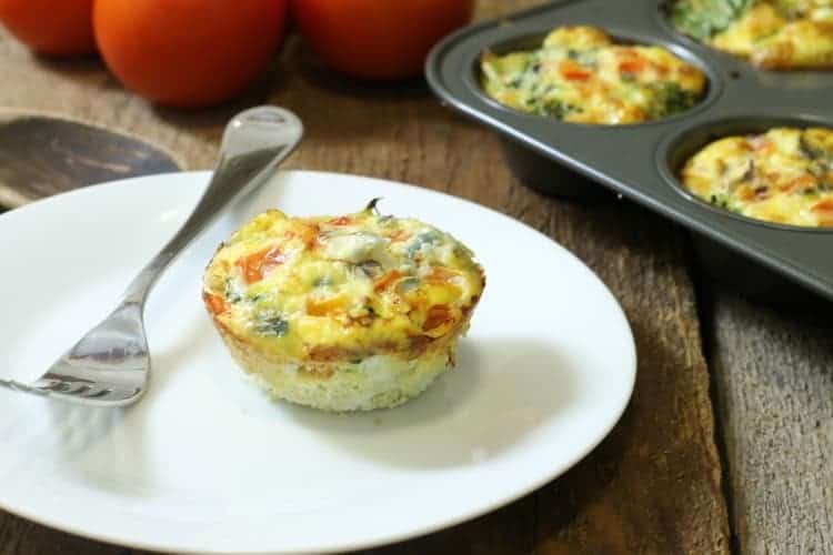 Veggie loaded breakfast egg muffin on a white plate