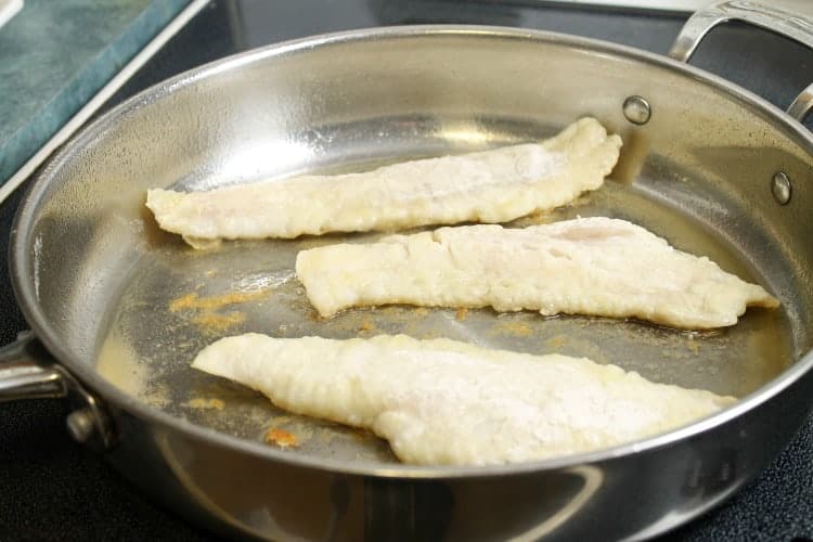 pan fried haddock starting to brown around the edges