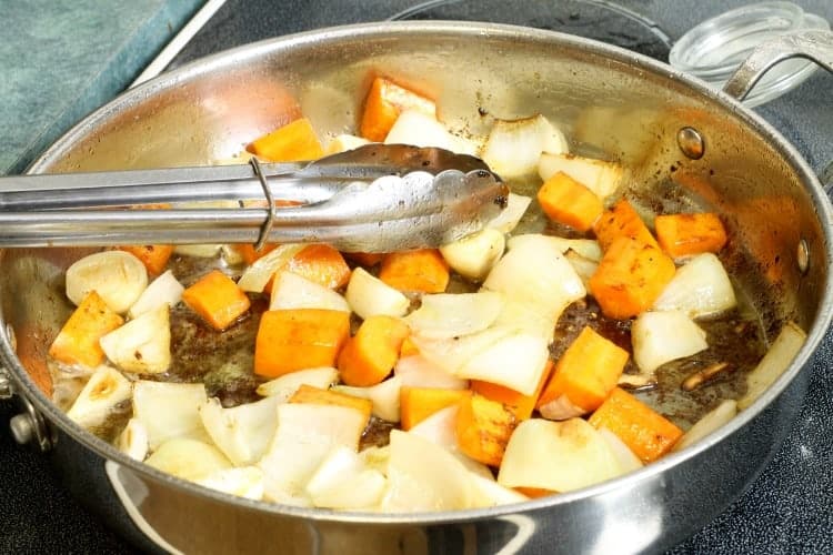 mirepoix being seared in a steel frying pan