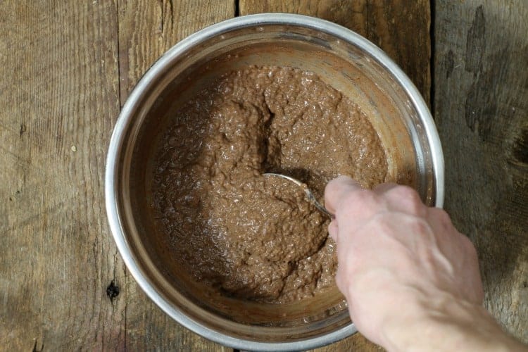 Chocolate chia seed pudding being stirred in a bowl once it has set