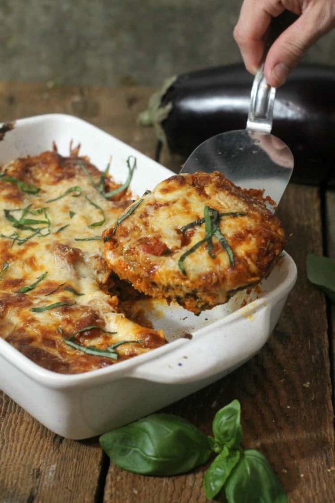 baked eggplant parmesan being served with a metal spatula