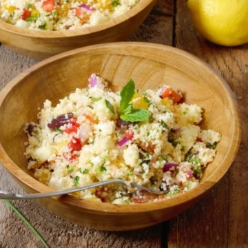 close up shot of Mediterranean Couscous Salad in a wooden bowl