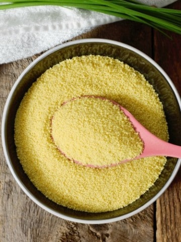 overhead shot of raw couscous in a black bowl