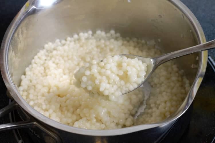 a pot of couscous filled with cooked Israeli couscous.