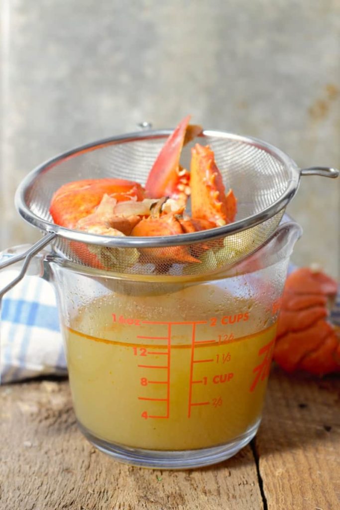 lobster stock strained into a glass measuring cup