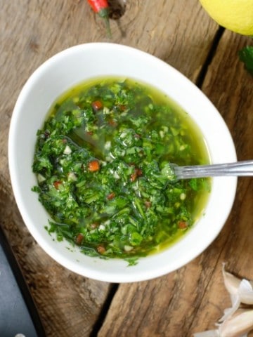 overhead photo of chimichurri in a white porcelain bowl