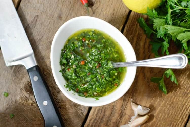 overhead photo of chimichurri in a white porcelain bowl