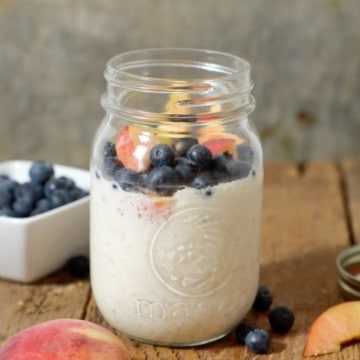 a close up shot of overnight oats made with greek yogurt and topped with fresh fruit