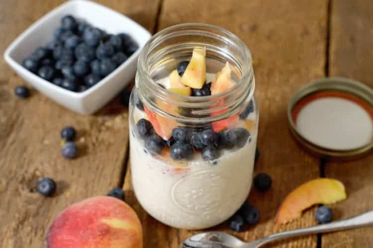 overnight oats made with greek yogurt and topped with fresh blueberries and peaches