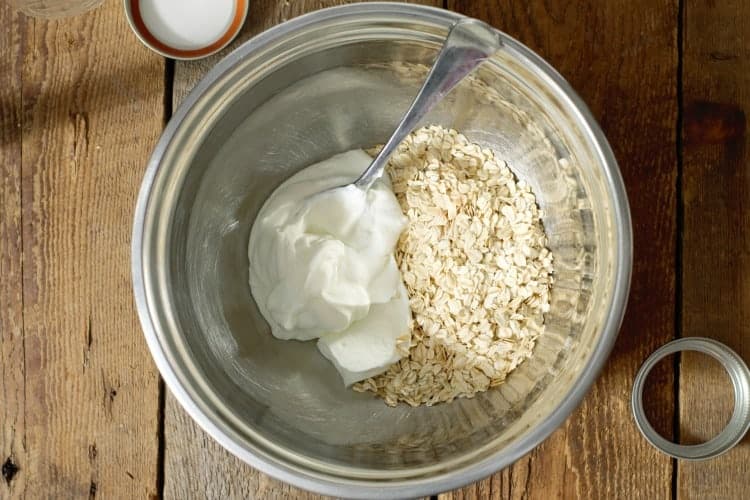 Whole rolled oats in a bowl with greek yogurt