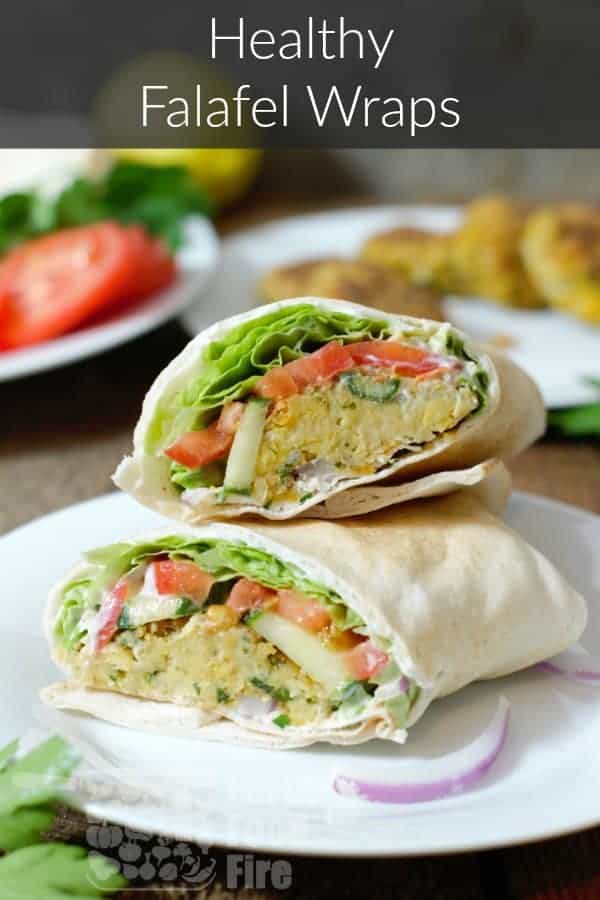a healthy falafal wrap cut in half on a white plate