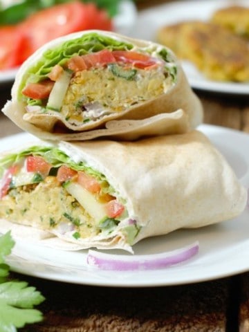 freshly made falafel wrap cut and stacked on a white plate