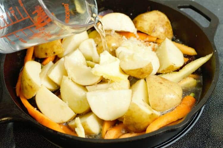 adding the root veg to a pan for hodge-podge