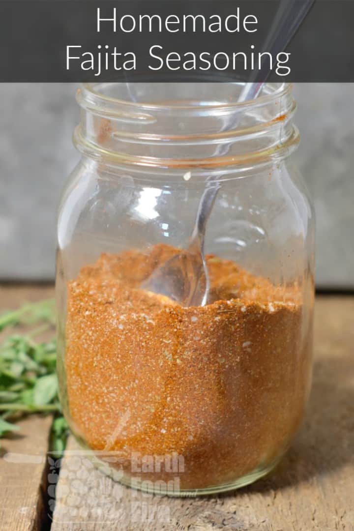 fajita spice mix in a glass mason jar on a wood table