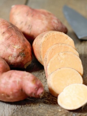 orange sweet potato whole, and sliced on display