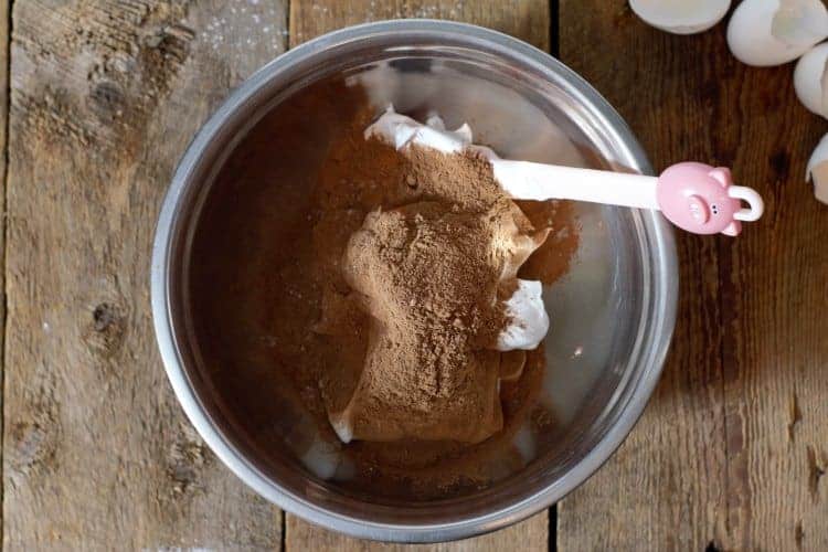 adding sifted cocoa powder and cornstarch to meringue