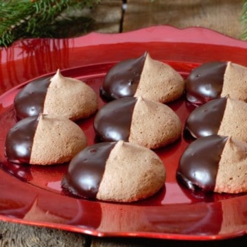 chocolate meringue cookies served on a red holiday themed platter