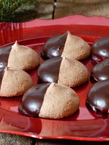 chocolate meringue cookies served on a red holiday themed platter