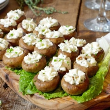 Goat cheese stuffed mushroom caps served on lettuce greens as an appetizer