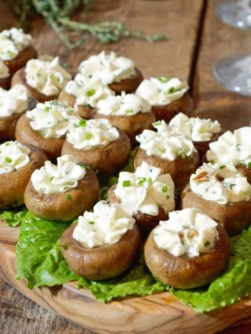 Goat cheese stuffed mushroom caps served on lettuce greens as an appetizer