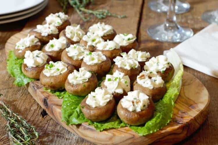 Goat cheese stuffed mushroom caps served on lettuce greens as an appetizer