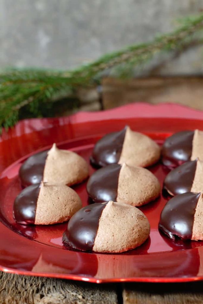 chocolate meringue cookies displayed on a red platter