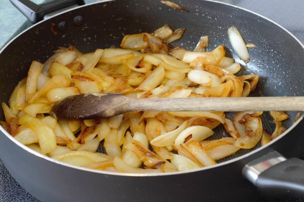sliced onions starting to slowly caramelize