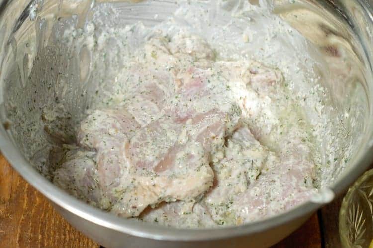 chicken thighs marinating in a greek yogurt marinade