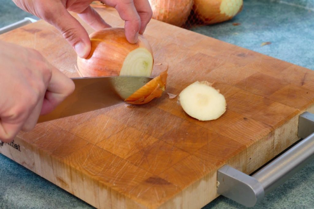 cutting the ends off an onion