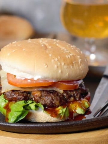 wild moose meat burger on a cast iron serving plate