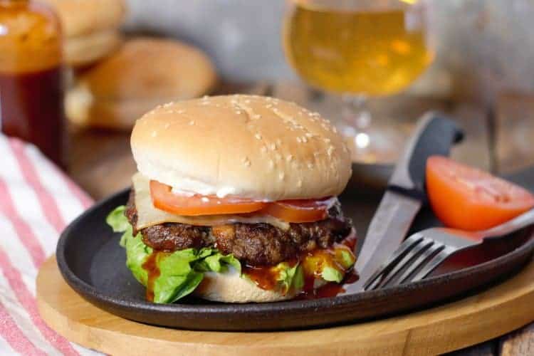 wild moose meat burger on a cast iron serving plate