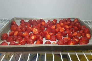 freezing strawberries on a tray in the freezer