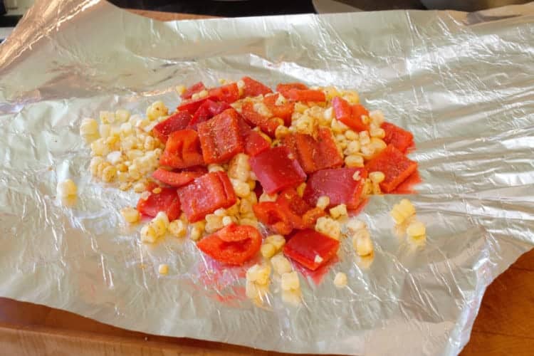 spreading the veggie mix on aluminum foil