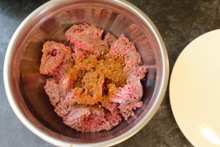 mixing the ground beef and mexican seasoning