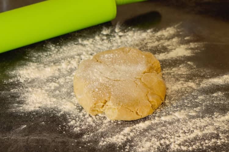 dusting the cookie dough before rolling it out