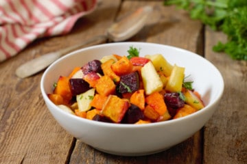 oven roasted root vegetable medley in a white porcelain bowl