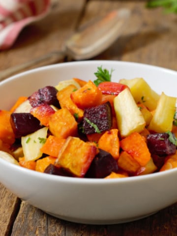 oven roasted root vegetable medley in a white porcelain bowl