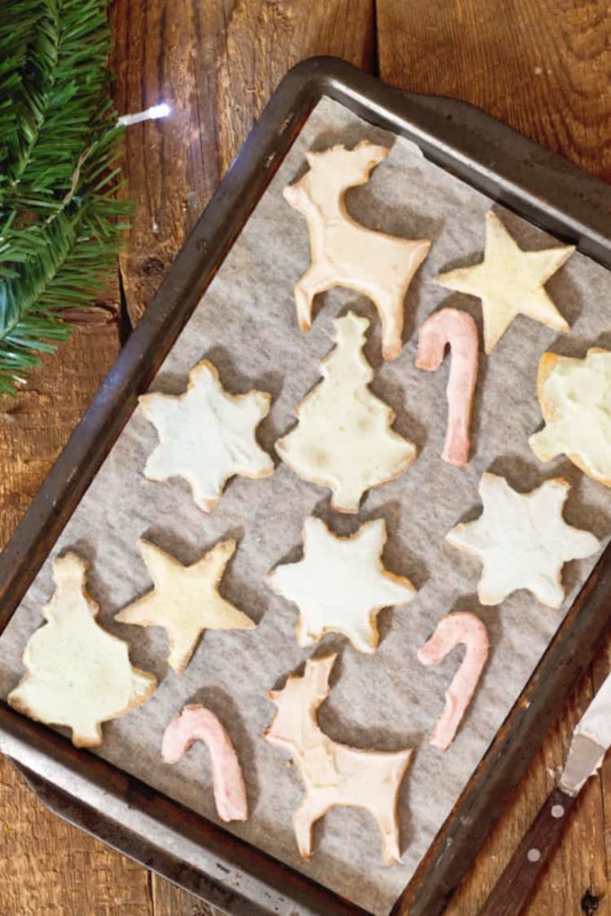 pastel colored sugar cookies on a sheet pan