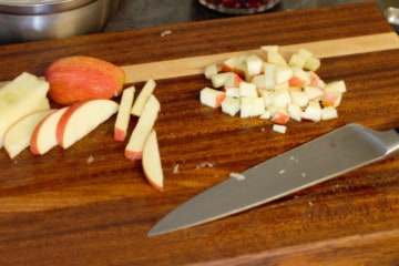 cutting fresh apple into small cubes