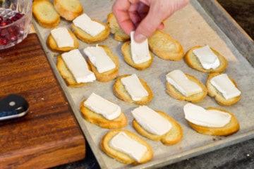 topping the crostini's with the sliced brie