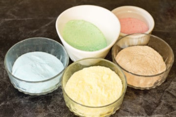 small dishes with pastel colored sugar in each