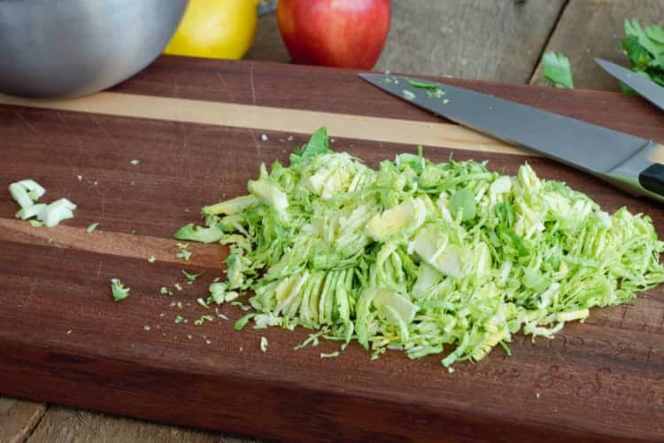 a pile of shredded brussels sprouts leaves on a wood cutting board