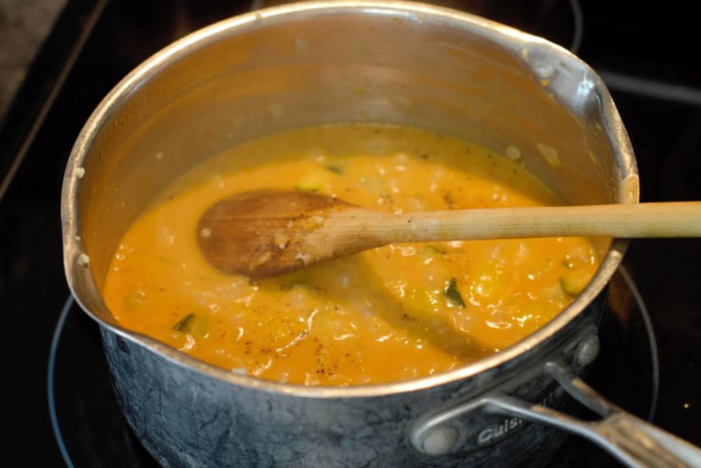 chickpea curry simmering in a pot on the stove
