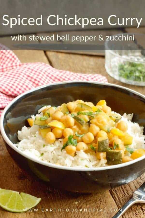 spiced chickpea curry served over basmati rice in a black bowl.