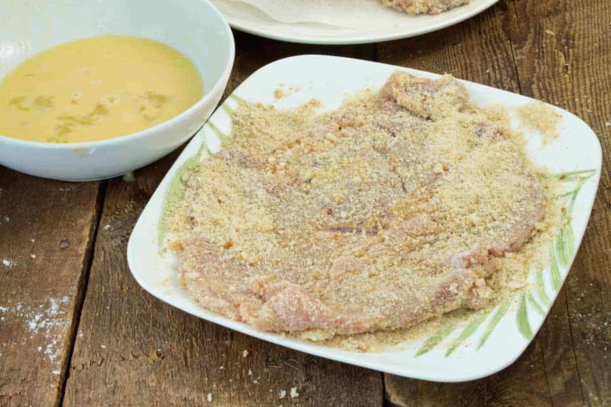 close up of a lightly breaded pork schnitzel on a plate