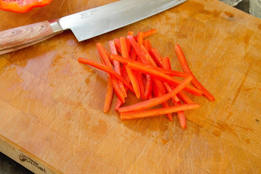 a close up of a red bell pepper julienne cut