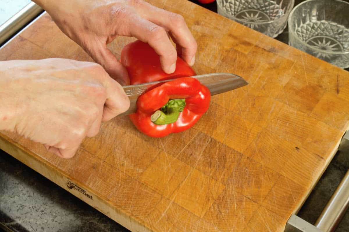 cutting off the top of a bell pepper