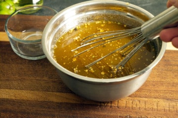 vinegar, sugar, and various spices being mixed in a small metal bowl
