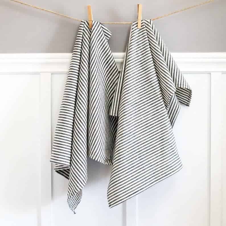 two black and white striped tea towels hanging on a line